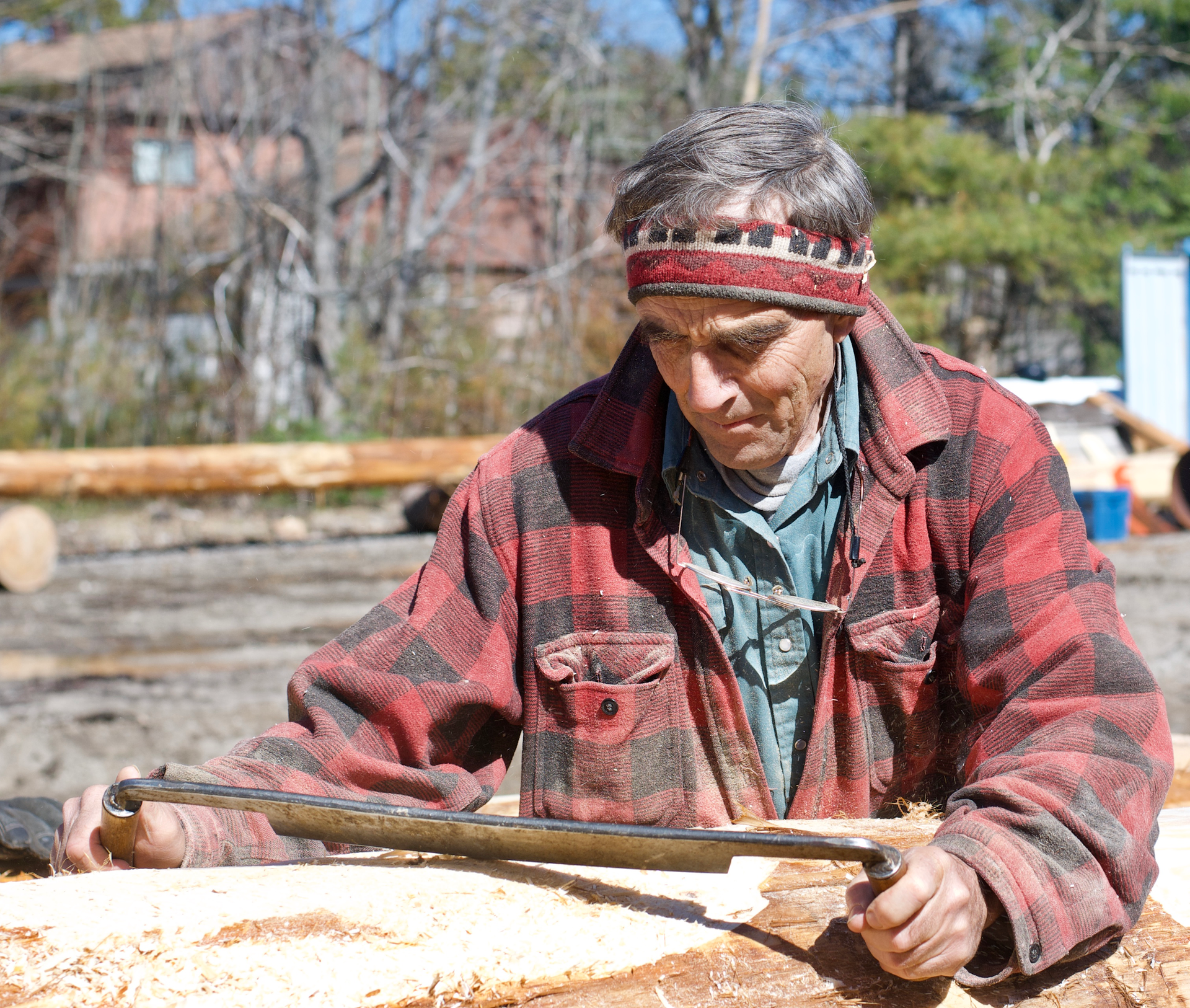Working to scribe a log for a perfect fit.