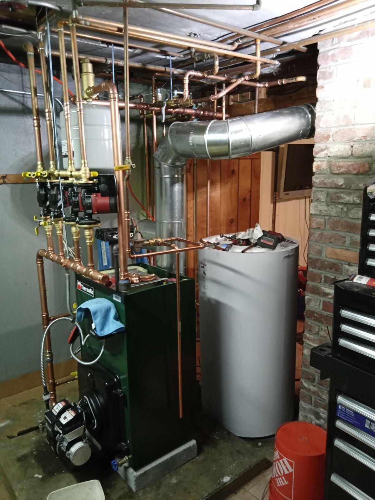 A room with a boiler and a water heater in it