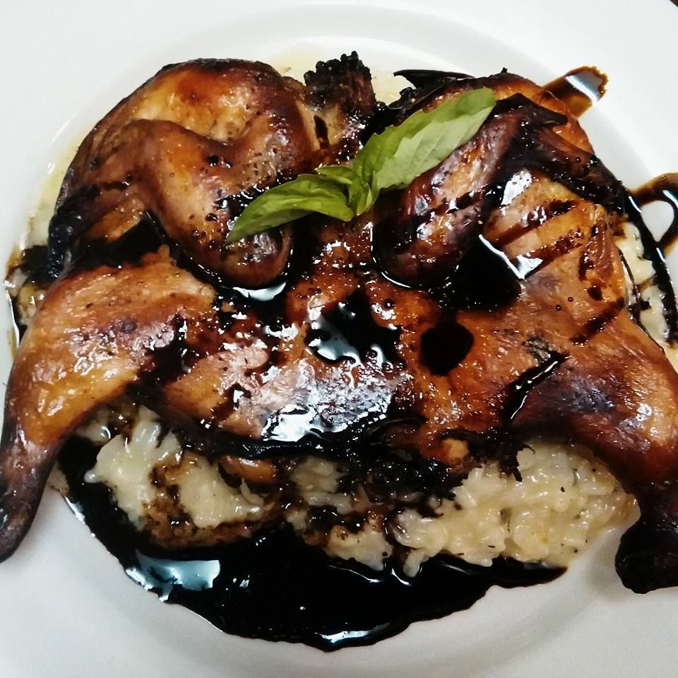 Roasted chicken with balsamic glaze on rice.