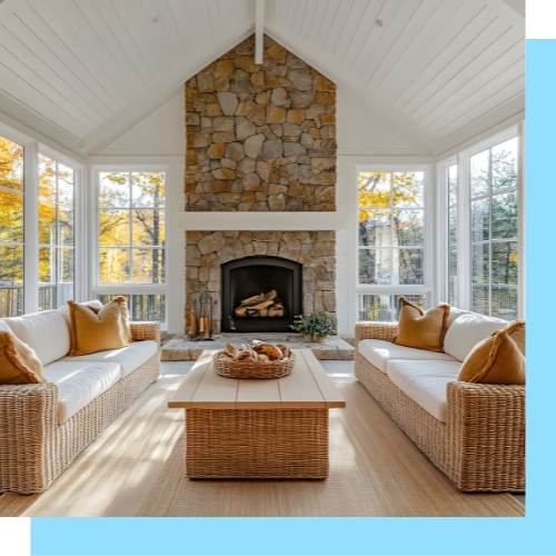 A living room with wicker furniture and a stone fireplace