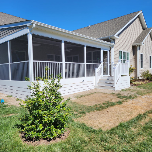 A house with a screened in porch and stairs