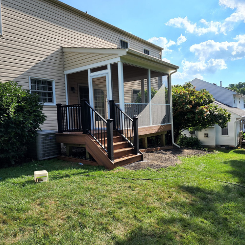 A house with a screened in porch and stairs