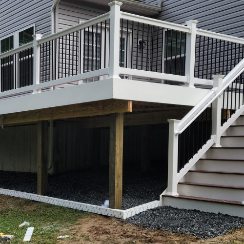 A white deck with stairs leading up to it