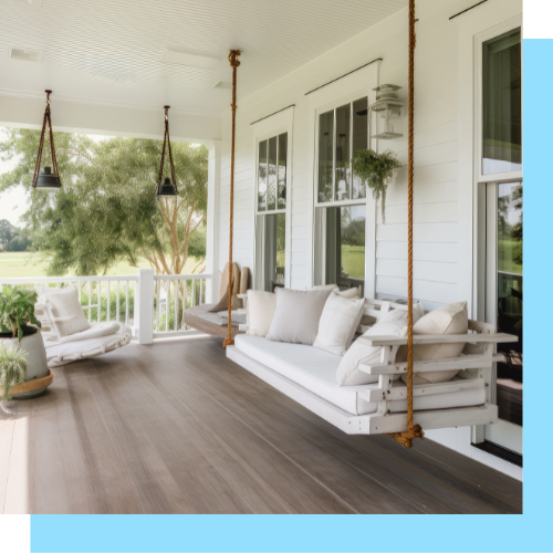 A porch with a swing hanging from the ceiling