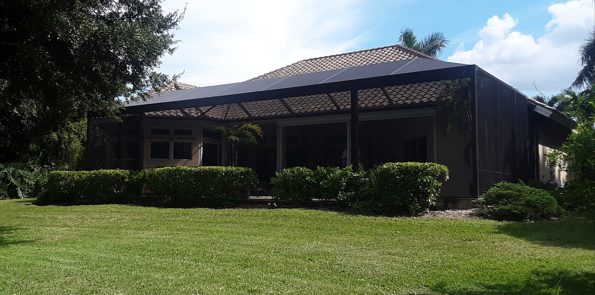 A house with a large lawn in front of it
