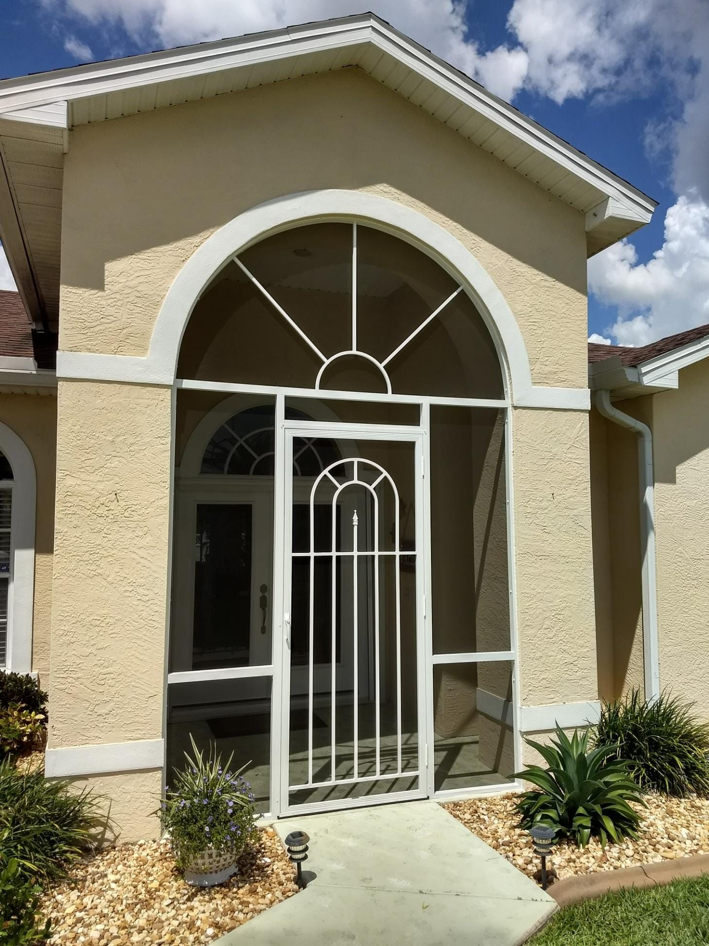 The front of a house with a screened in porch