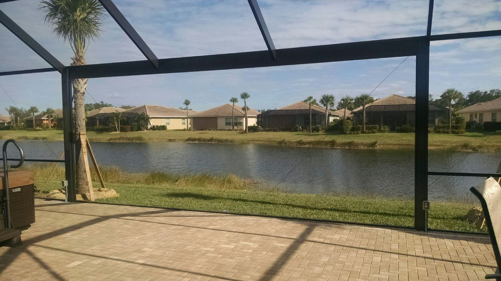 A screened in area with a view of a lake