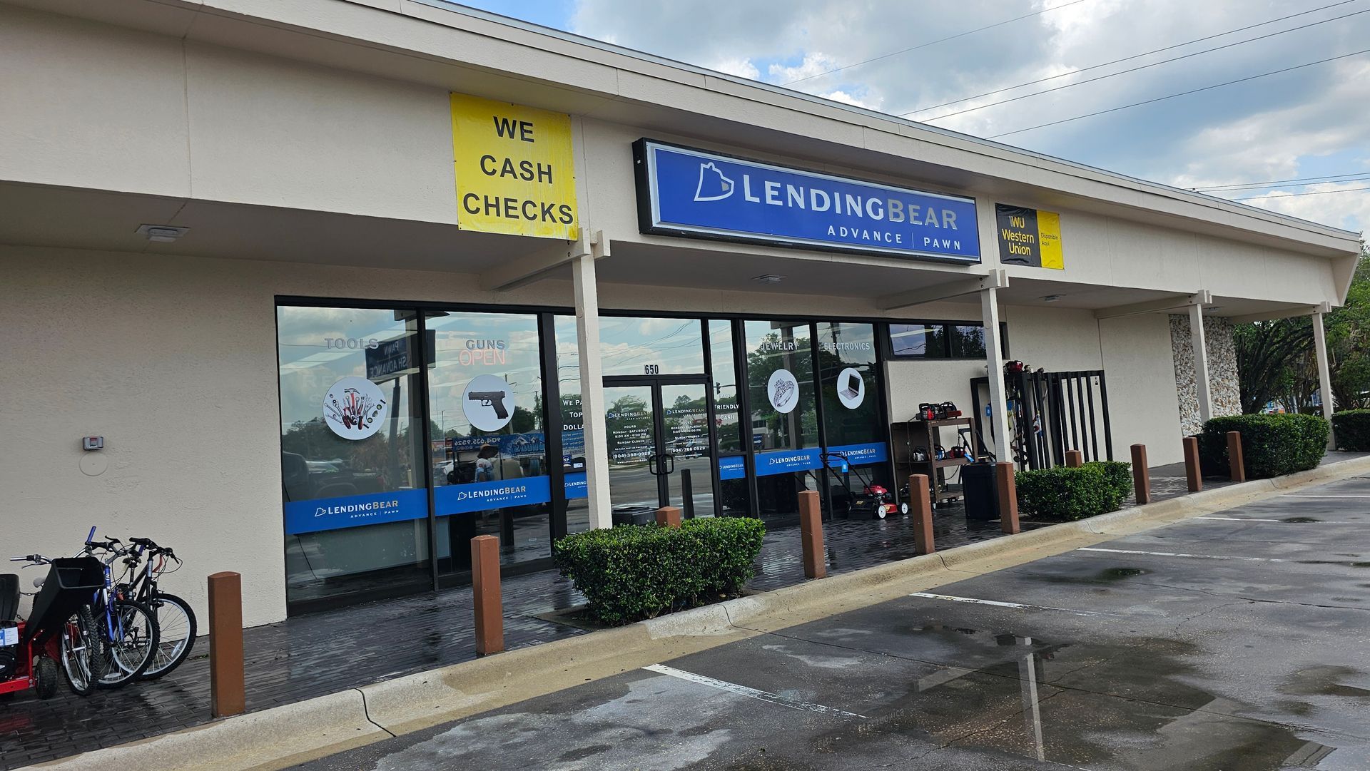 Exterior of a Lending Bear store. Blue and yellow signage, large windows, accessible entrance.