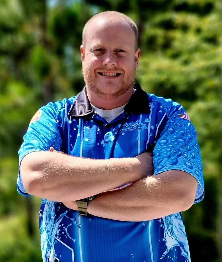 The back of a house with a satellite dish on the roof.