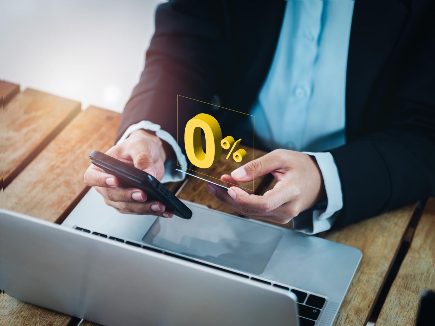 A person in a business suit holding a smartphone with a 3D 0% interest rate icon hovering above it.