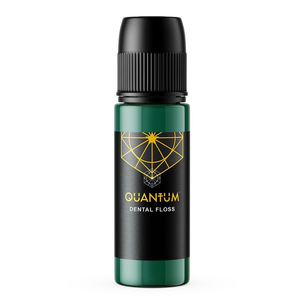 Bottle of Quantum dental floss with black cap and green label, featuring a gold geometric design.