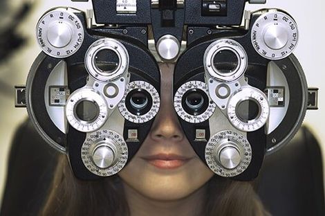 Woman's Face Behind Eye Exam Machine - Eye Exams in Fredericksburg, VA