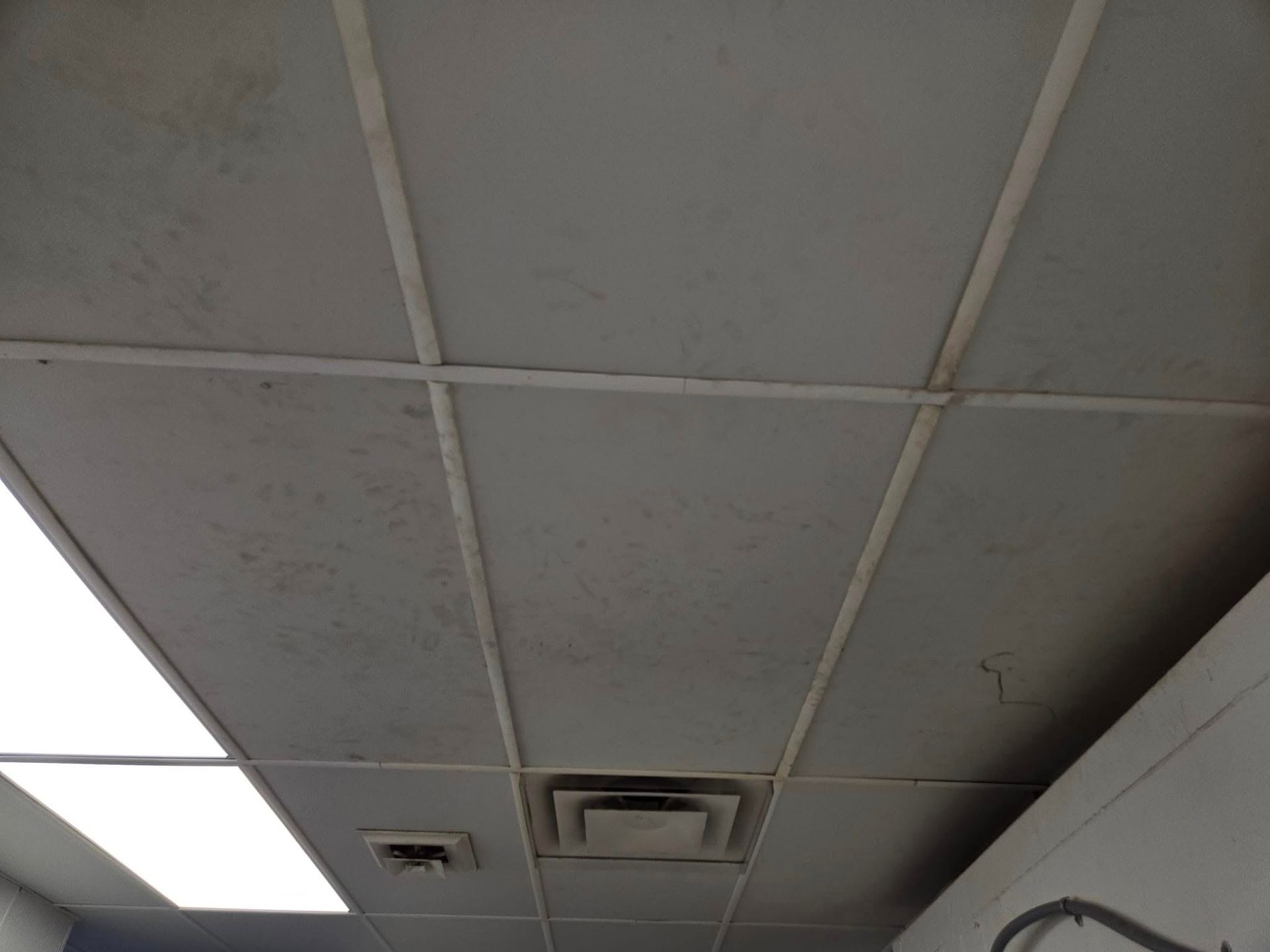A dirty ceiling with a few lights on it