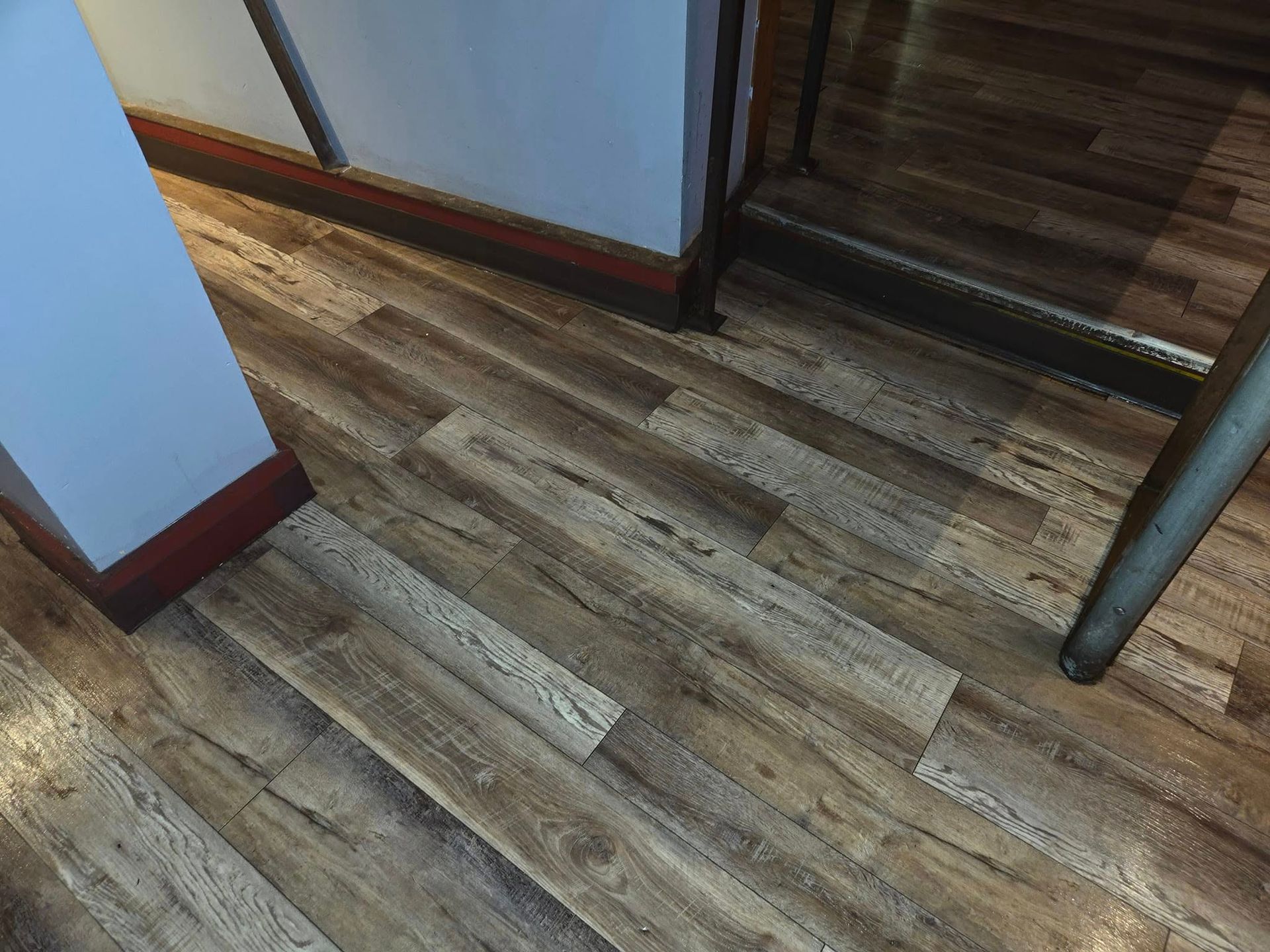 A close up of a wooden floor in a room.