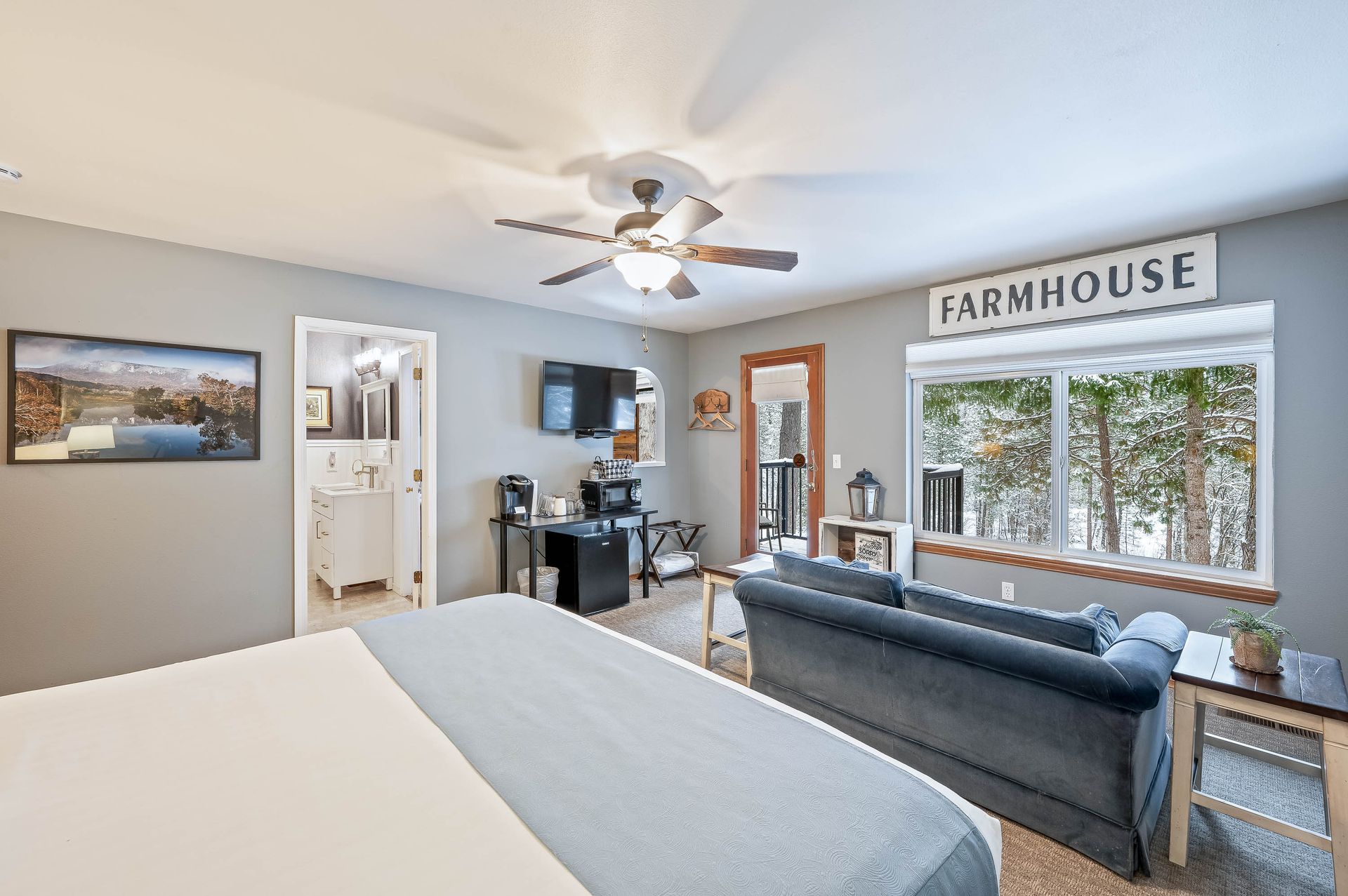 Bedroom with a blue couch, TV, and 