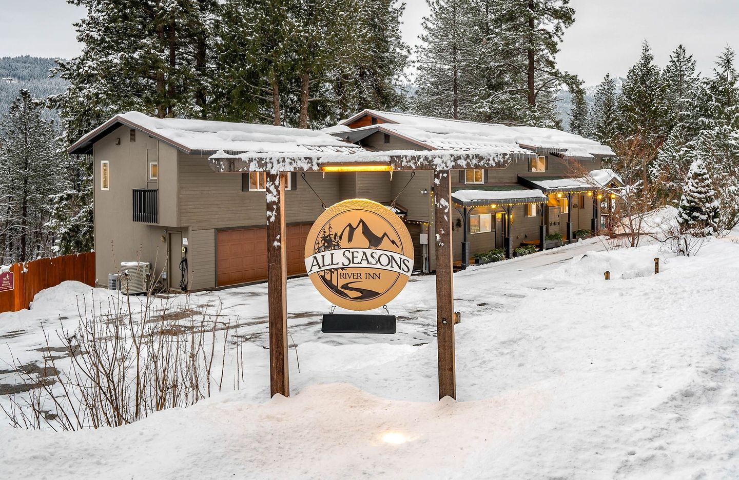 Snowy lodge with sign reading 