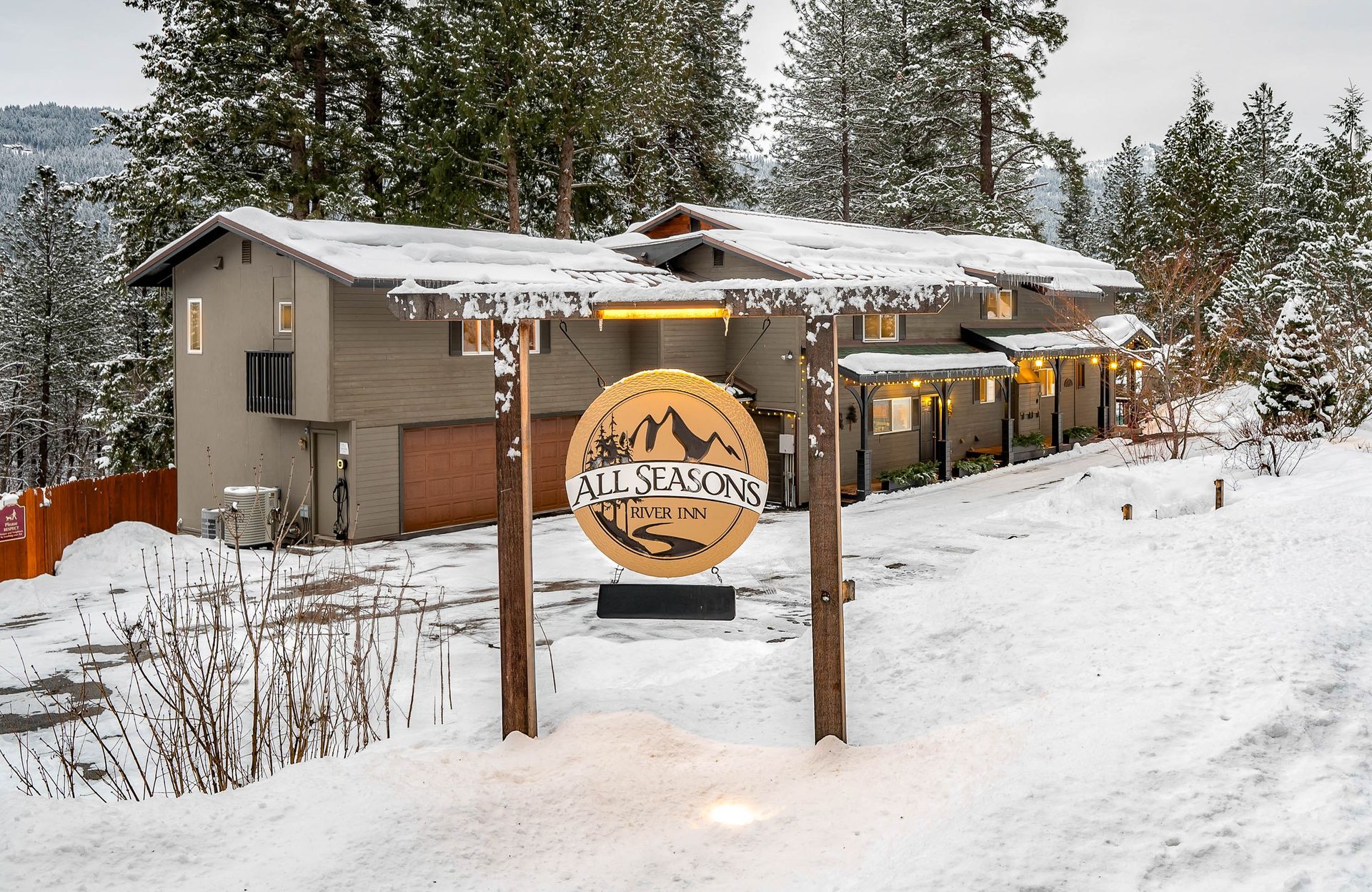 Snowy lodge with sign reading 