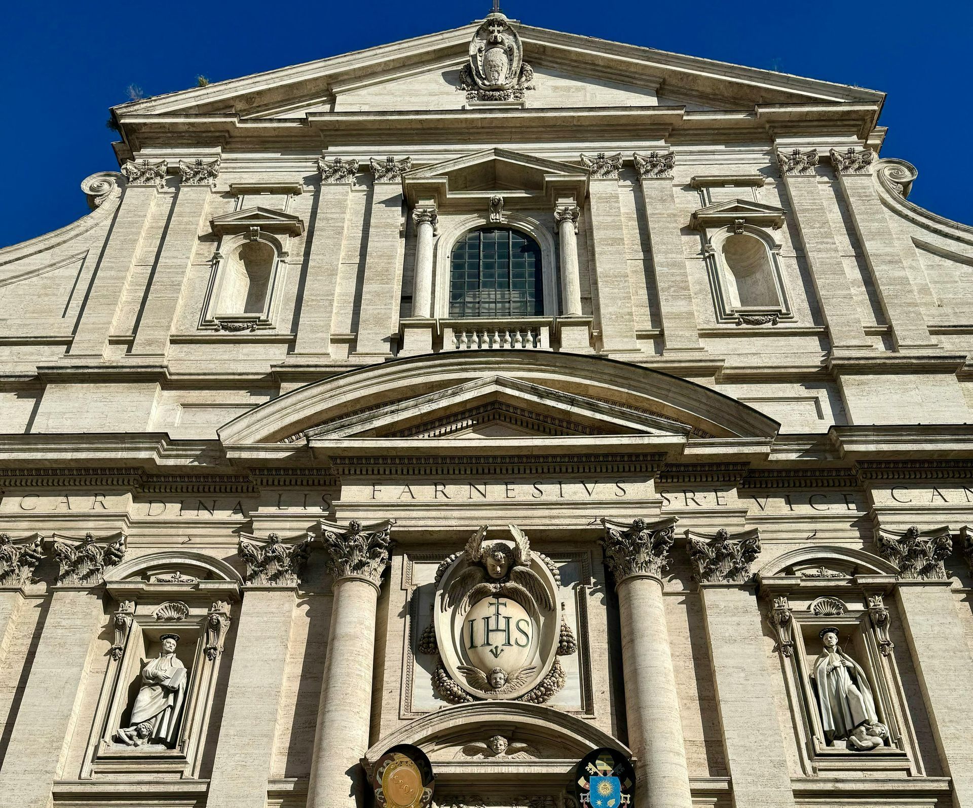 Facade of the Church of Gesù in Rome, showcasing Baroque architecture with intricate details