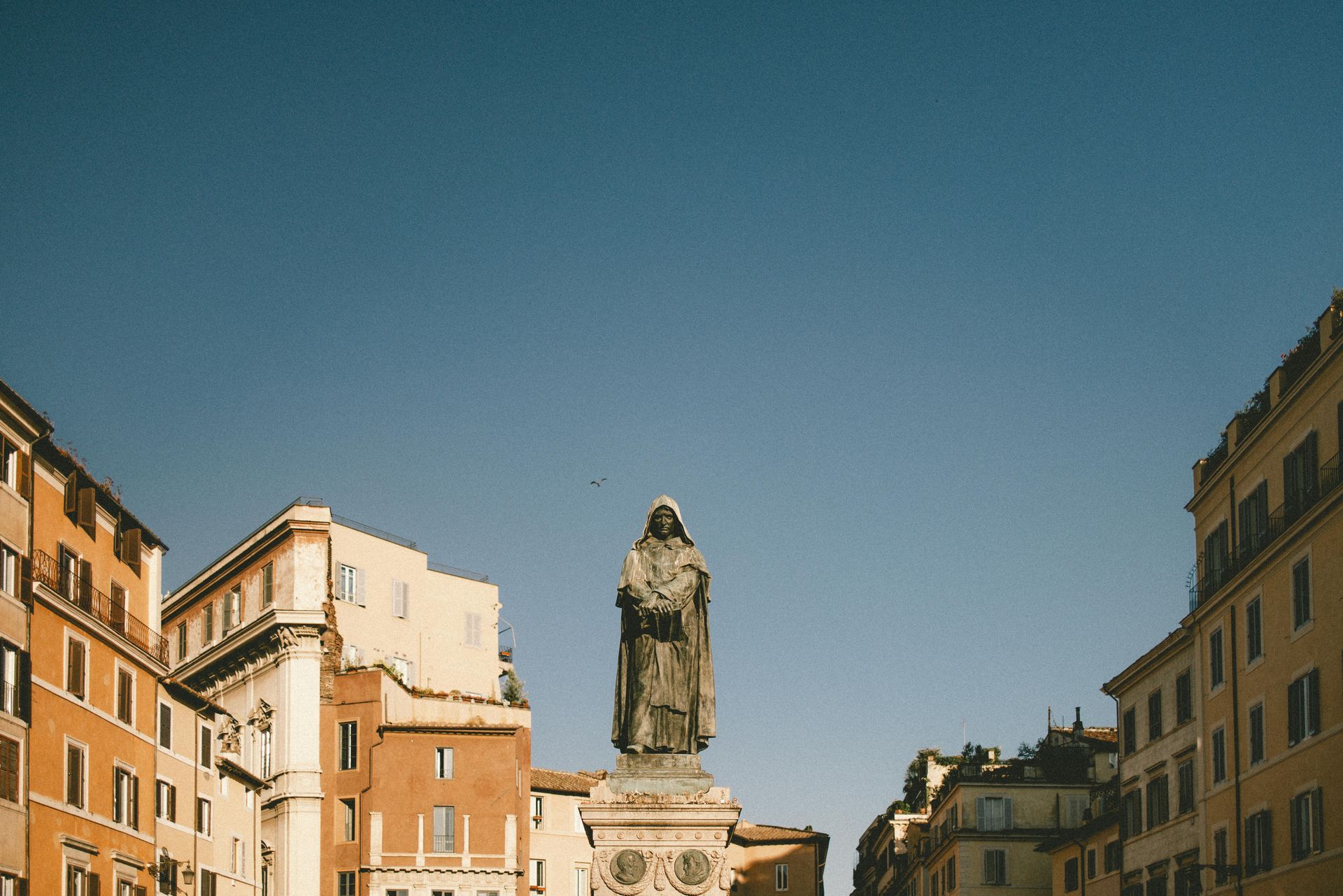 Statue of Giordano Bruno in Campo dei Fiori in Rome, with classical buildings in the background