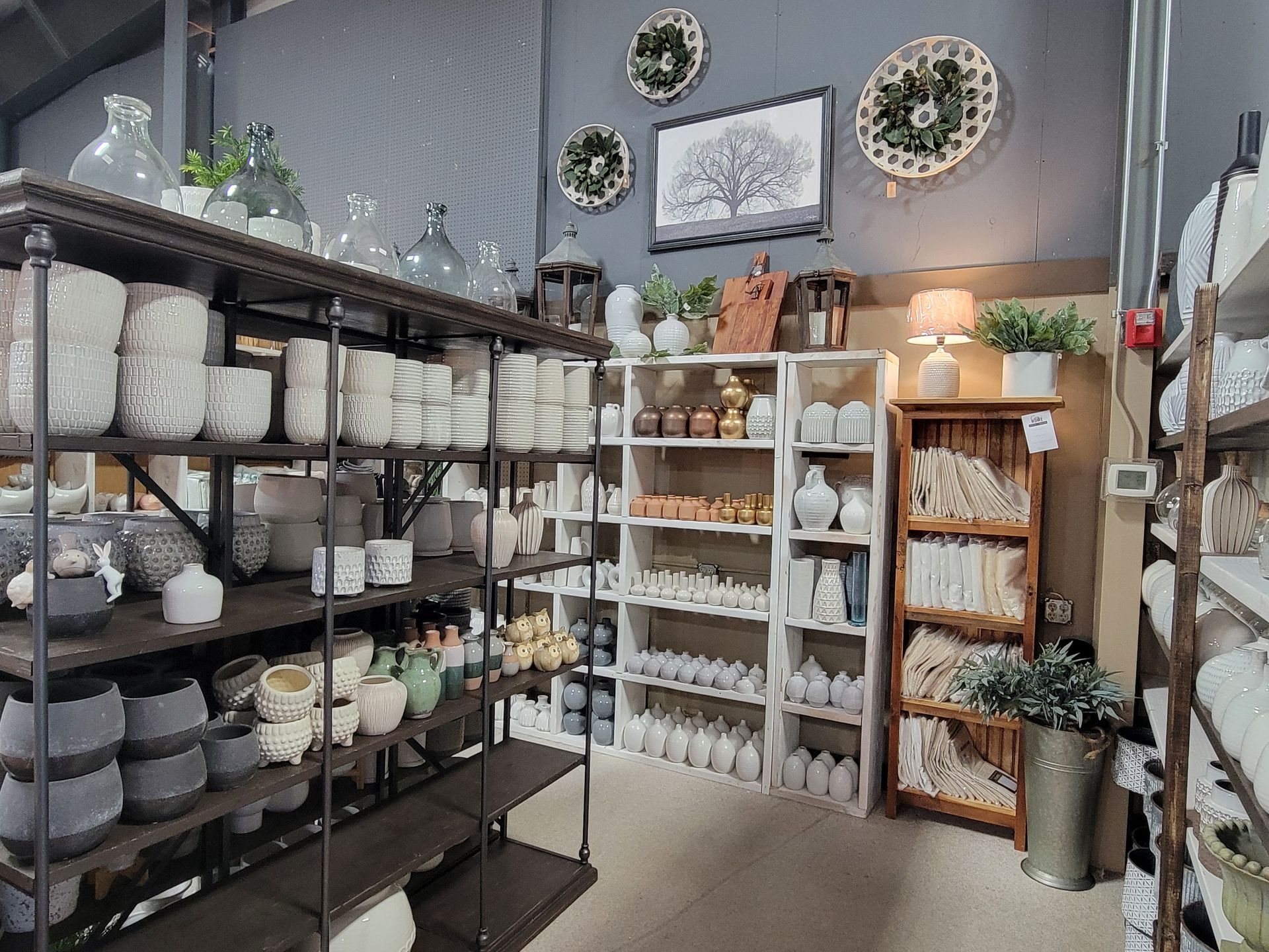 A variety of ceramic vases, pottery, and home decor items in a store.