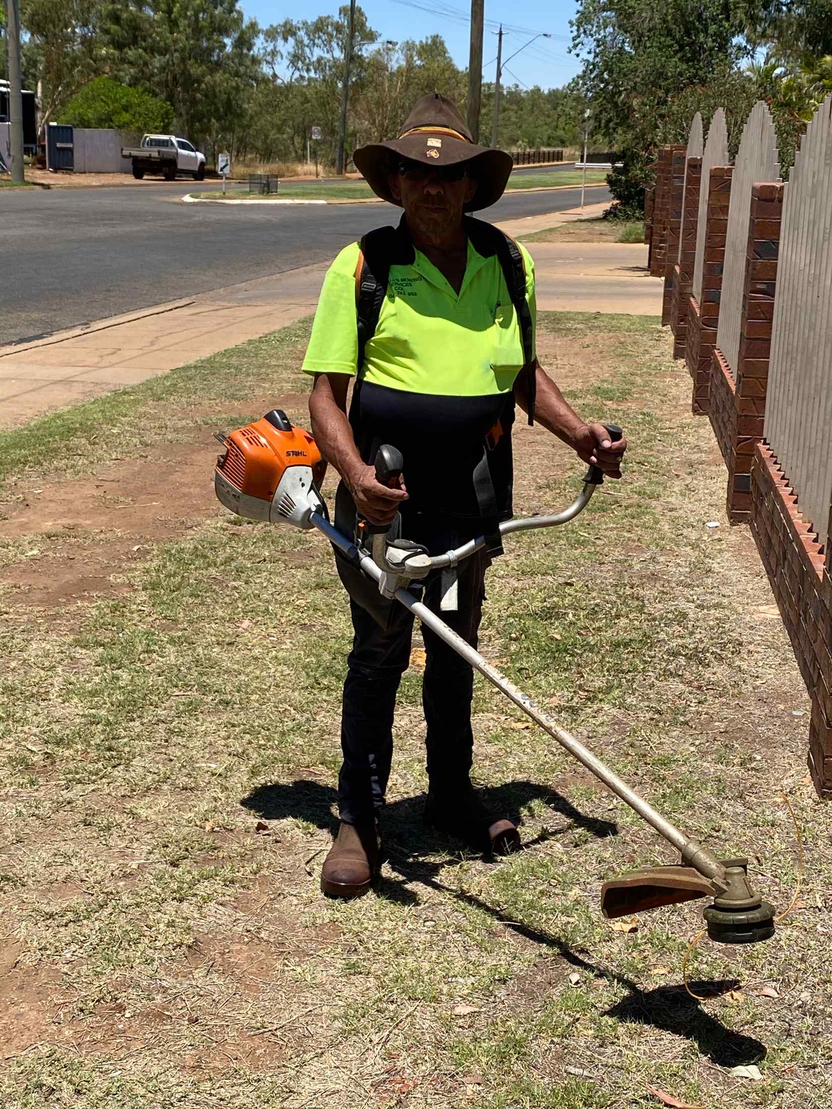 Man Cutting Grass 3— Gallery in Mount Isa, QLD