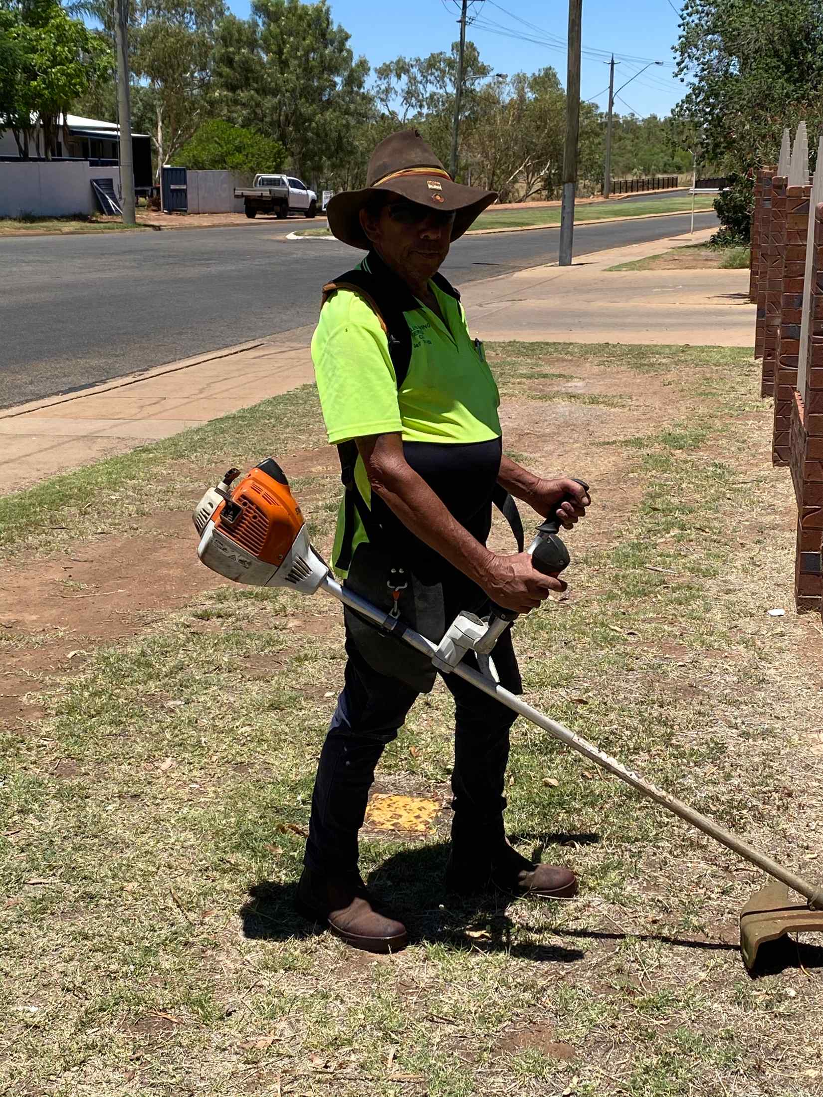 Man Cutting Grass 2— Gallery in Mount Isa, QLD