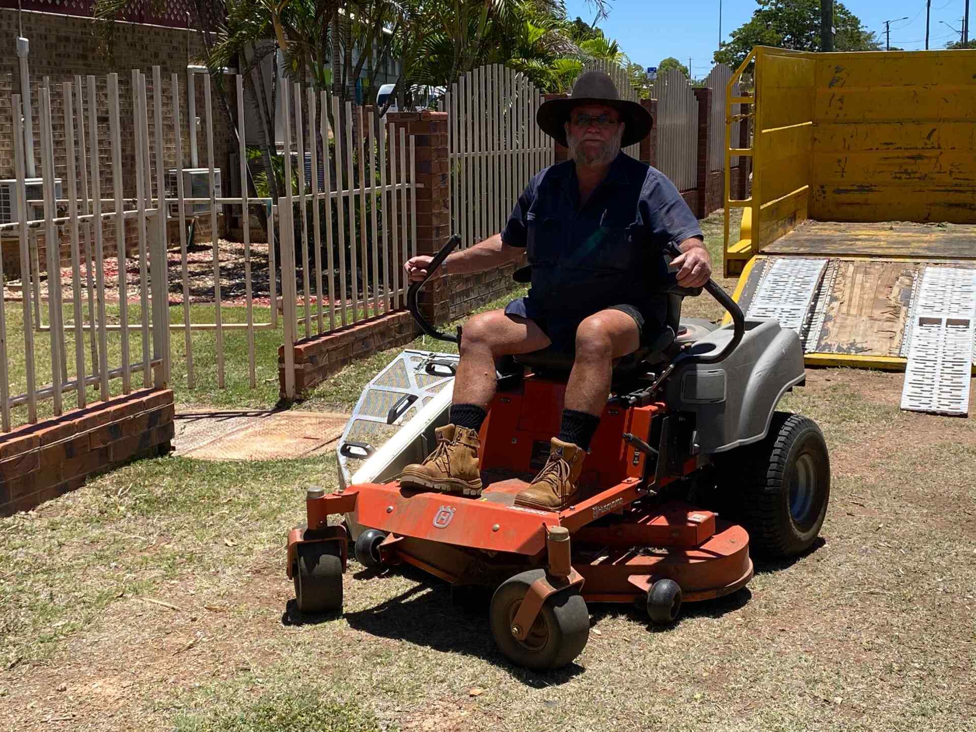Man Using Mowing Machine with Track — Gallery in Mount Isa, QLD
