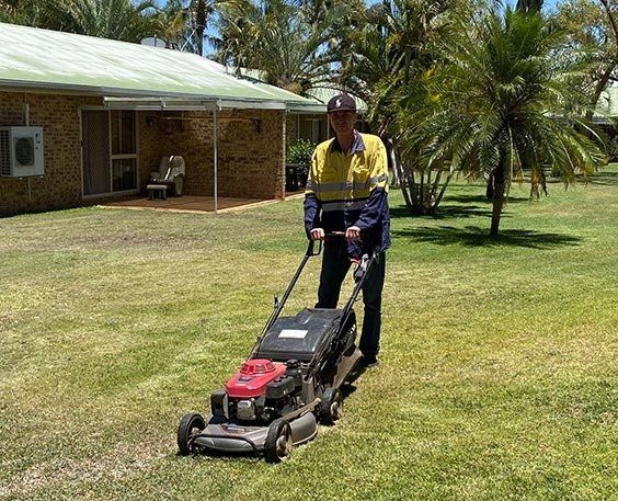 Man Mowing the Garden — Lawn Mowing in Mount Isa, QLD