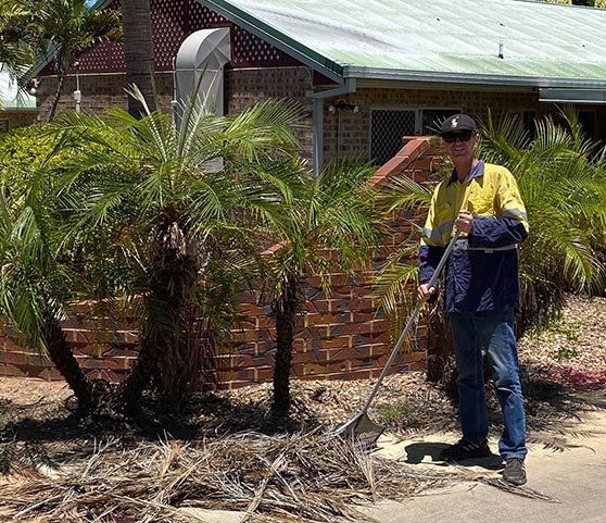 Man Cleaning Trimmed Tree — Tree Trimming in Mount Isa, QLD