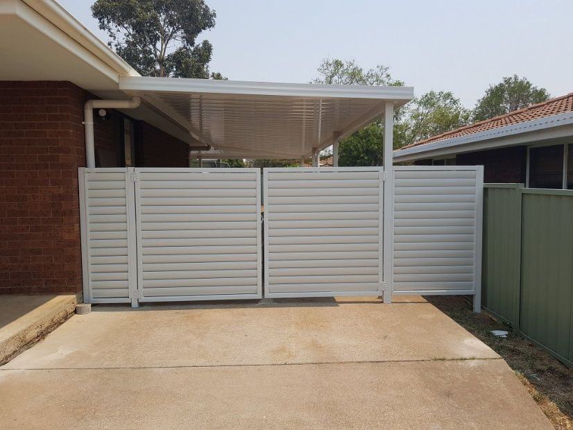 A White Fence Surrounds A Metal Gate — Anne & Ron Johnson Fencing in Werris Creek, NSW