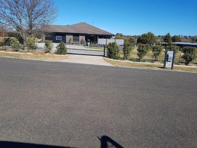 A Driveway With A House And A Parked Car, Featuring An Automatic Gate — Anne & Ron Johnson Fencing in Werris Creek, NSW