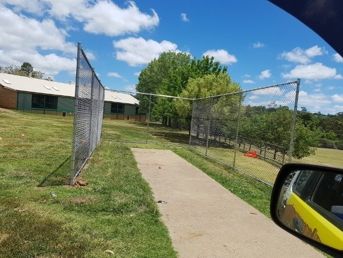 A Car's Side Mirror Reflects A Spacious Baseball Field And Its Surrounding Fence — Anne & Ron Johnson Fencing in Werris Creek, NSW