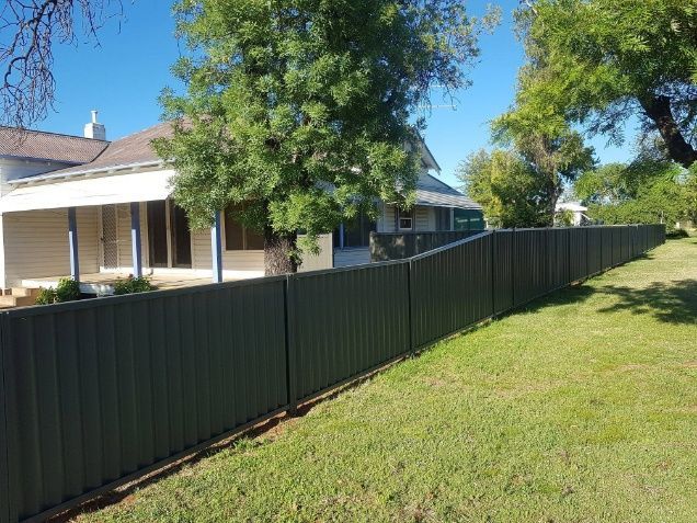 A House Is Bordered By A Fence — Anne & Ron Johnson Fencing in Werris Creek, NSW