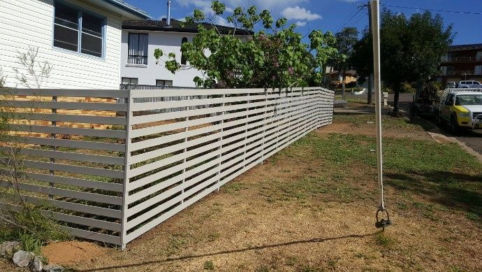 A Slat Fence Is Build Beside The House To Defined Boundary For The Yard — Anne & Ron Johnson Fencing in Werris Creek, NSW