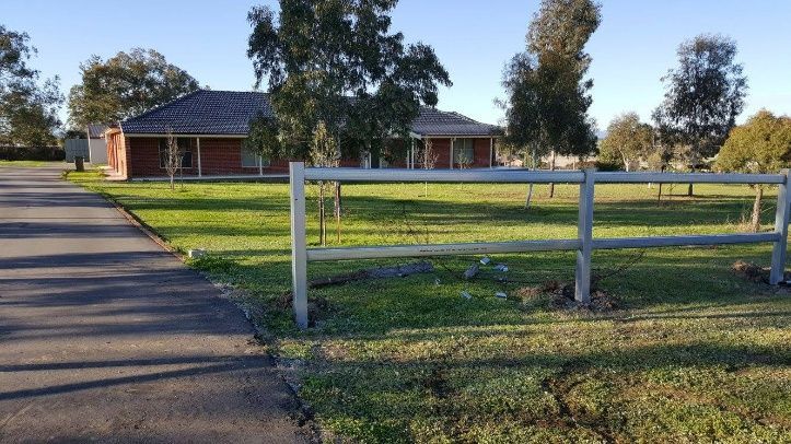 A Driveway Leading To A House, Framed By A Fence, With The Home Visible In The Background — Anne & Ron Johnson Fencing in Werris Creek, NSW