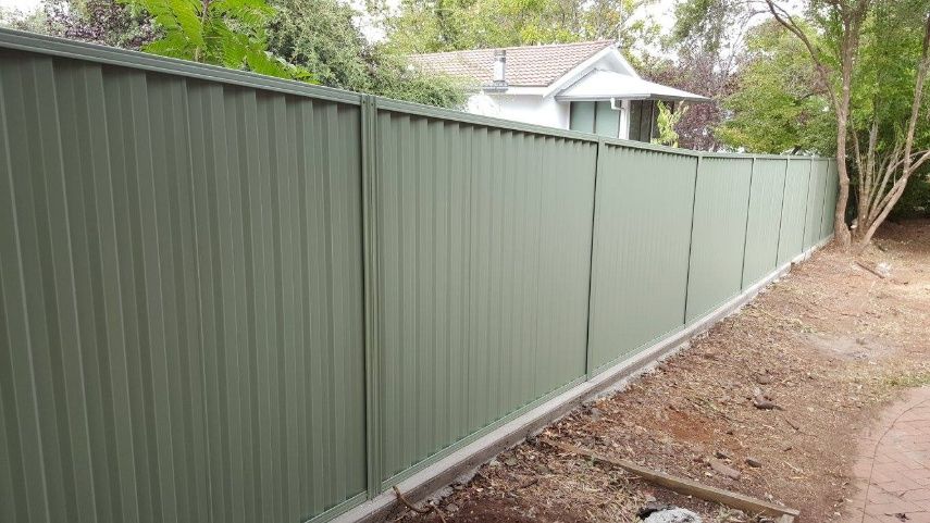 A Fence With Green Panels On The Side — Anne & Ron Johnson Fencing in Werris Creek, NSW