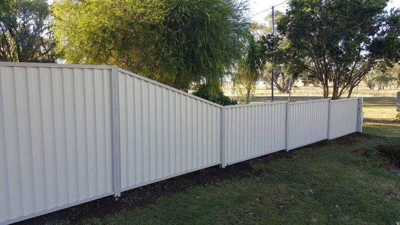  A White Fence With Trees Behind It — Anne & Ron Johnson Fencing in Werris Creek, NSW