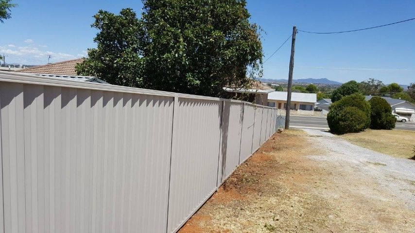 A White Fence Adjacent To A Brown Fence — Anne & Ron Johnson Fencing in Werris Creek, NSW