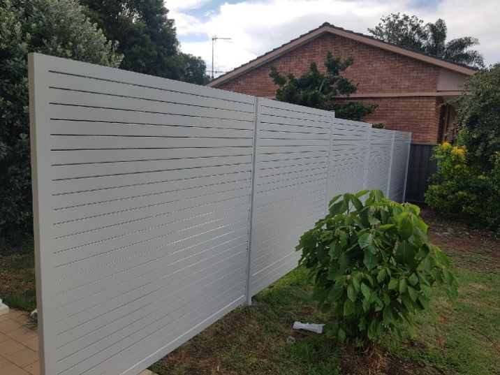 A Backyard Featuring A Slat Fence With White Wooden Slats — Anne & Ron Johnson Fencing in Werris Creek, NSW