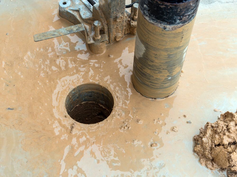 A Hole in the Ground is Being Drilled by a Machine — Anne & Ron Johnson Fencing in Werris Creek, NSW