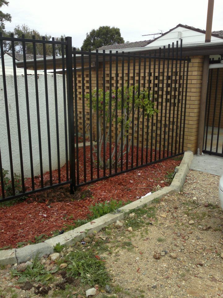 A Raised Garden Bed Filled With Mulch And Various Green Plants — Anne & Ron Johnson Fencing in Werris Creek, NSW