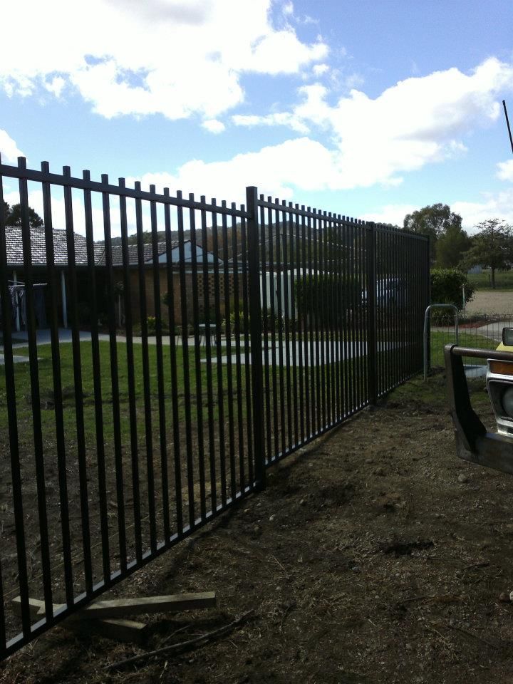 A White Picket Fence Borders A Lovely House — Anne & Ron Johnson Fencing in Werris Creek, NSW