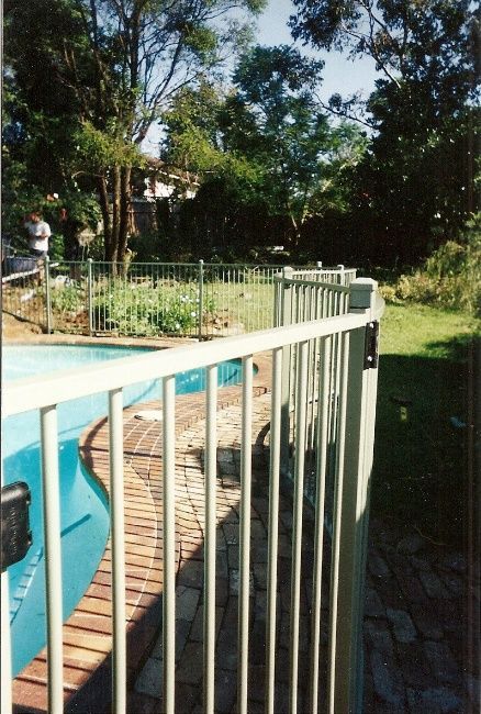 A Swimming Pool Secured By A Fence And Gate — Anne & Ron Johnson Fencing in Werris Creek, NSW