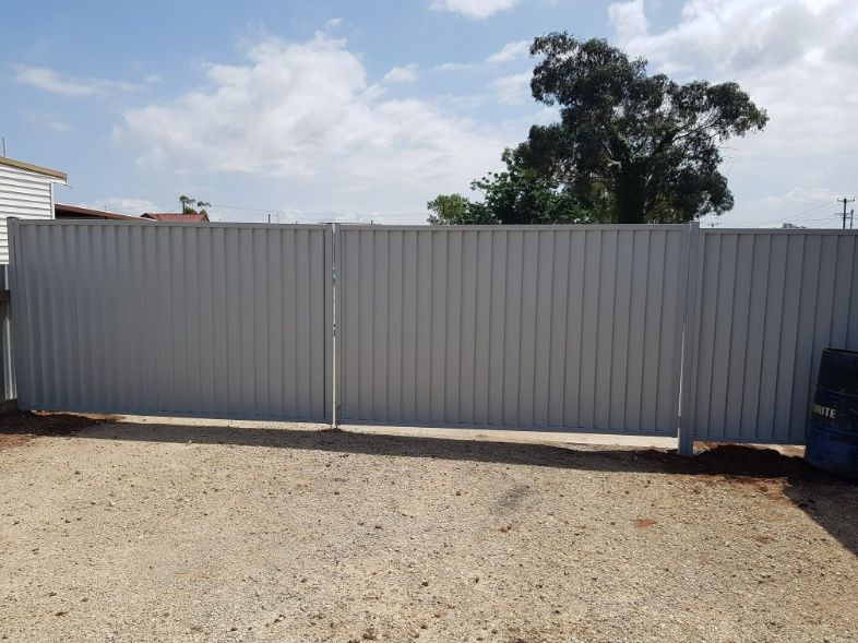 A Large White Fence With A Gate Stands Tall — Anne & Ron Johnson Fencing in Werris Creek, NSW