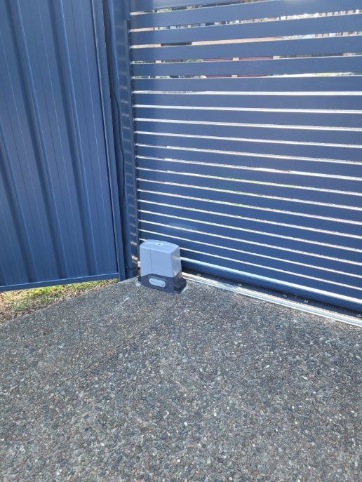  A Blue Auto Gate Made Of Metal — Anne & Ron Johnson Fencing in Werris Creek, NSW