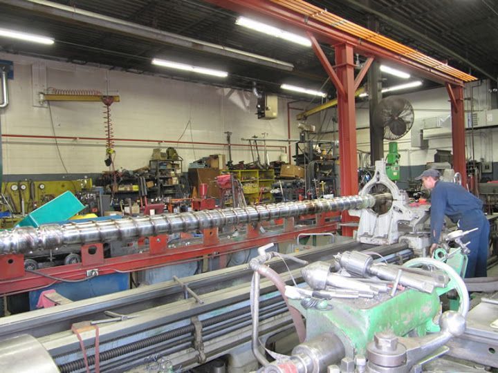 Worker using Centerless Grinding Long Bar Machine — Oak Creek, WI — AFI Direct Service Inc.