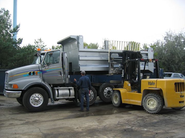 Forklift is Lifting the Truck Dump Box — Oak Creek, WI — AFI Direct Service Inc.