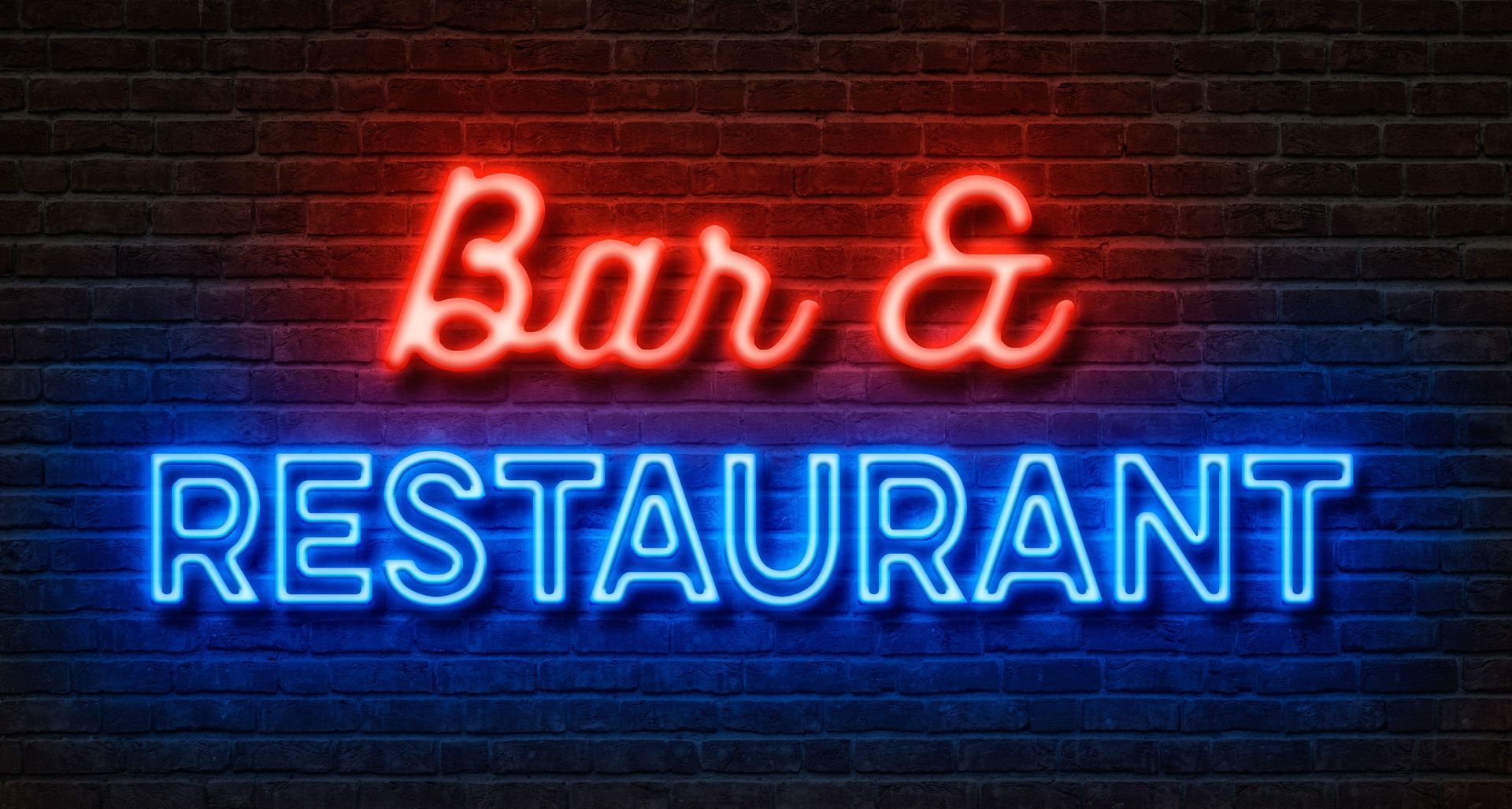 Neon sign reading “Bar & Restaurant” in red and blue on a dark brick wall.