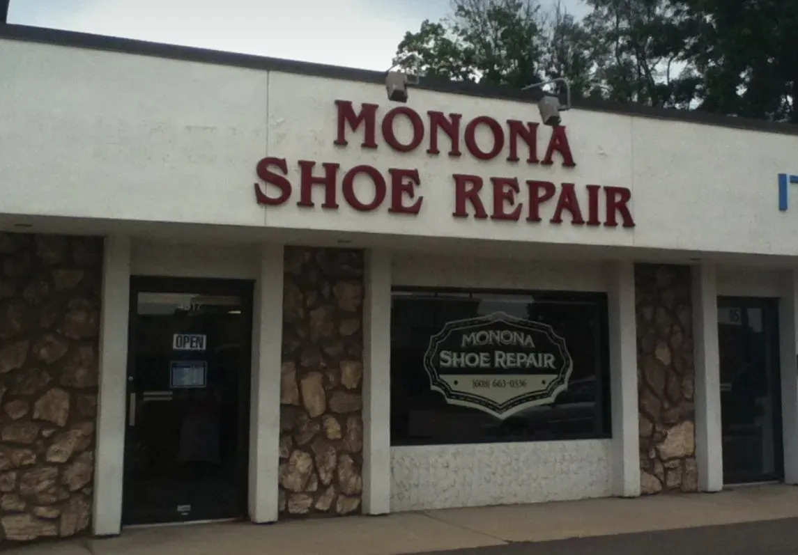Monona Shoe Repair storefront with stone facade and sign above entrance