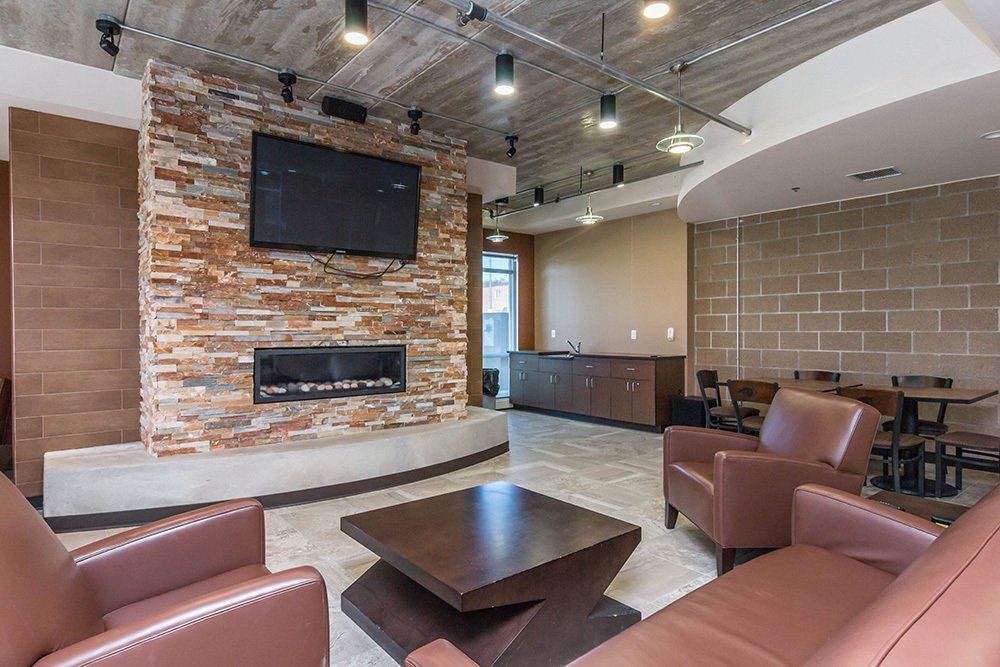 community space with tv and chairs